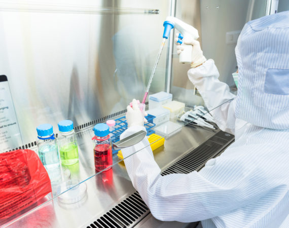 A regenerative medicine scientist in sterile coverall gown